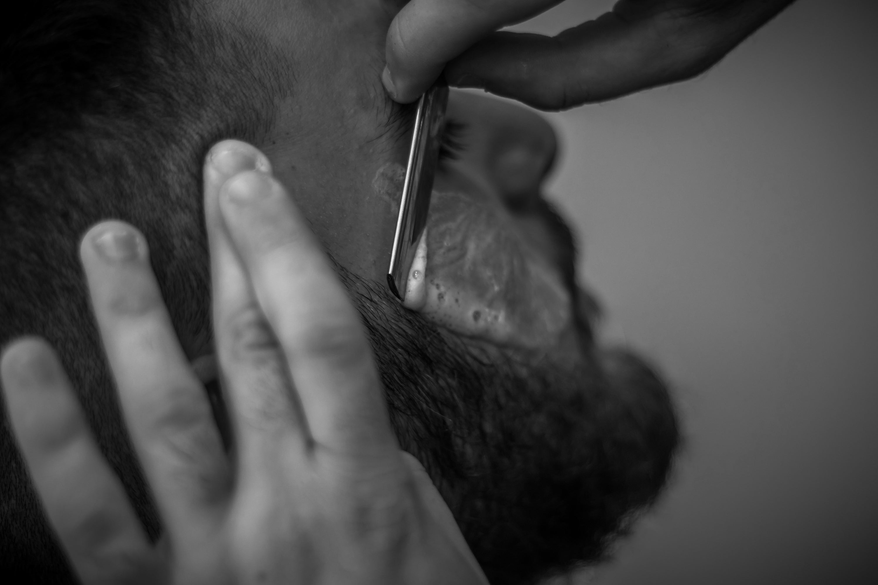 shaing beard with a cut-throat razor